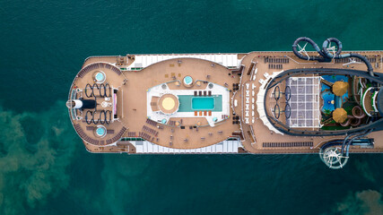 Aerial view top down of stern upper deck of luxurious cruise ship with swimming pool and leisure area © Aerial Specialized 