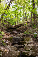 Small stream trickling down a rocky hillside in the woods of Creve Coeur Park in Creve Coeur near Saint Louis, MO
