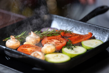 Vegetables are fried in a pan