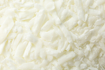 White soy wax flakes as background, closeup