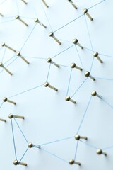 Network connection. Nails linked together by thread on white table, closeup
