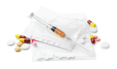 Drug addiction. Different pills, plastic bags with powder and syringe isolated on white