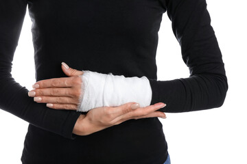Woman with medical bandage on wrist against white background, closeup