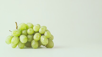Fresh green grapes with water droplets on minimalist white background
