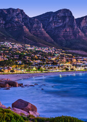 Fototapeta premium Vertical Shot of Camps Bay Beach with Twelve Apostles Mountain in the Background, Cape Town, South Africa