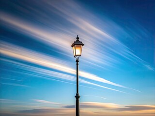 Obraz premium Long exposure captures a tranquil scene: lone lamppost against a dreamy, minimalist nightscape.