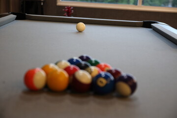 Pool balls lined up to be broken on a billiards table