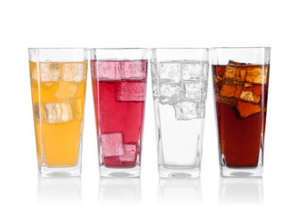 Soda water of different flavors with ice cubes in glasses isolated on white