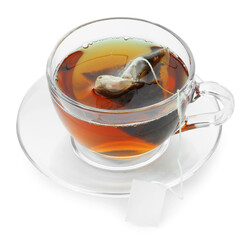 Tea bag in glass cup with hot drink isolated on white