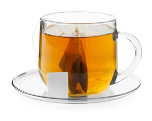 Tea bag in glass cup with hot drink isolated on white