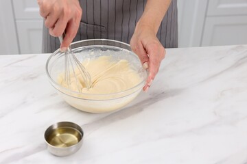 Woman making dough at white marble table indoors, closeup