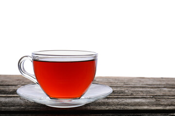 Refreshing black tea in cup on wooden table against white background