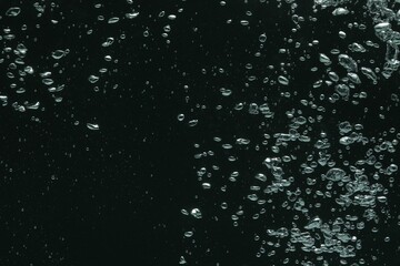 Many water bubbles on black background, closeup
