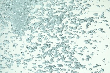 Many water bubbles on light background, closeup