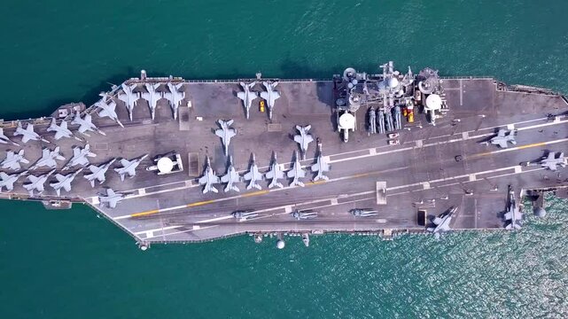 Aircraft carriers, warships, nuclear-powered ships, carrying a large number of aircraft sailing at sea.