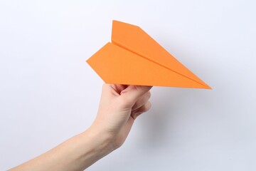 Woman with handmade paper plane on white background, closeup