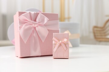 Gift boxes for wedding day on white table indoors, space for text