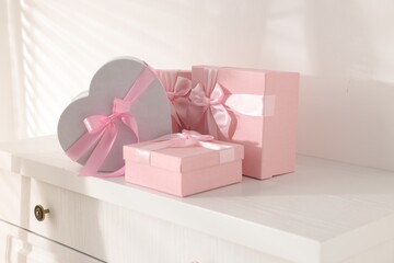 Gift boxes for wedding day on white chest of drawers indoors