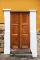 Wooden old door on a colorful wall.