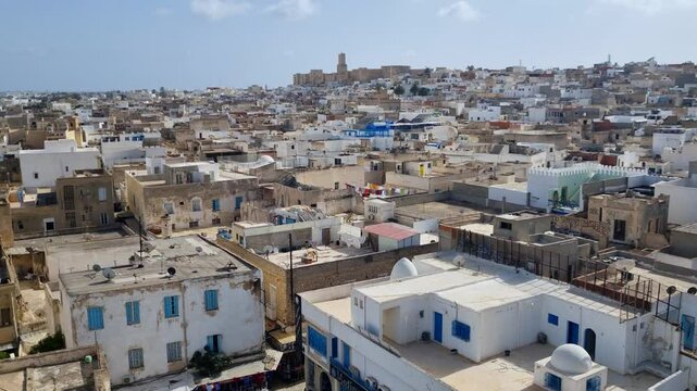 View from the Ribat of Sousse over the old city and medina, highlighting traditional Arab architecture under a cloudy sky.