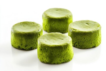 Four Green Matcha Cakes Arranged on White Background
