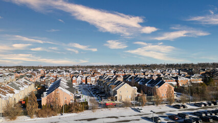 Snow-dusted suburban neighborhood on a sunny winter day.