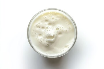 A glass of milk shows a playful foam face