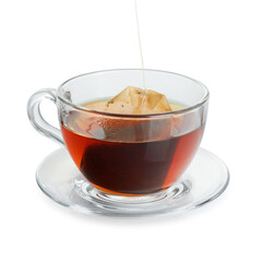 Putting tea bag into glass cup on white background