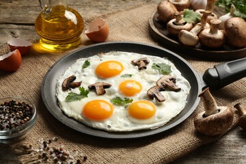 Tasty fried eggs with mushrooms and parsley served on wooden table