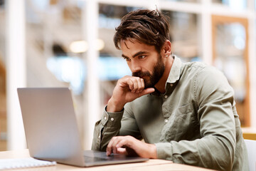 Laptop, thinking and business man in office with idea, brainstorming and career insights. Creative...