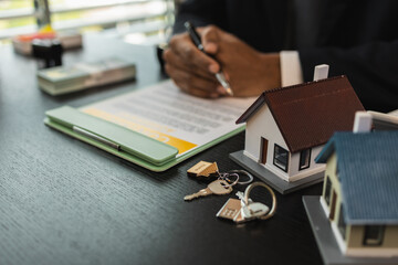 a real estate agent is explaining the details of a home purchase contract to a buyer, he is telling them that is is a worthwhile investment, property, estate, mortgage