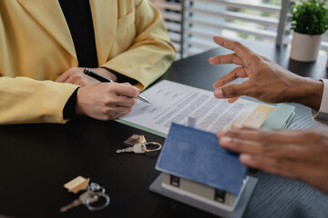 a real estate agent is explaining the details of a home purchase contract to a buyer, he is telling them that is is a worthwhile investment, property, estate, mortgage