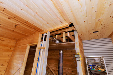 Remodeling wooden sauna interior while highlighting the structural beams, ceiling design.