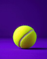 A vibrant yellow tennis ball rests against a striking purple background, showcasing its texture and design.