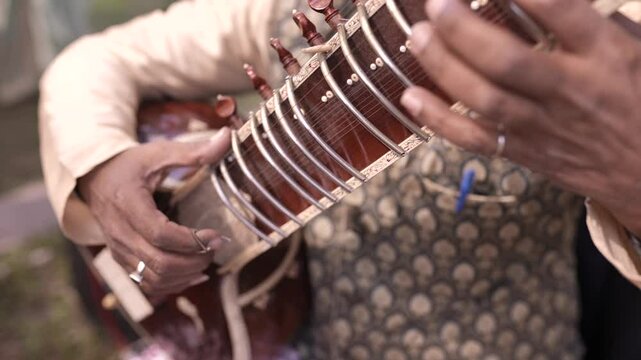 A Slow Motion Shot of a man Playing Sitar at an Indian Wedding in New Delhi, India
