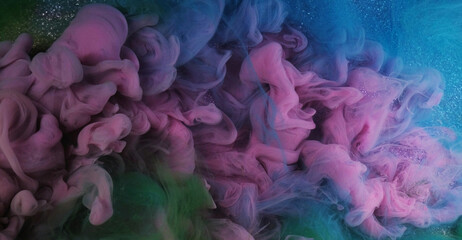 Color water flow. Ink smoke. Defocused pink green blue glowing splashes paint texture haze floating on purple shimmering abstract art light background.