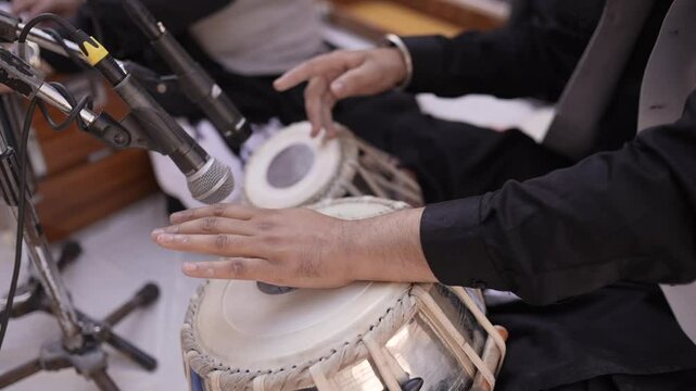 A shot of a man playing  tabla at an Indian Wedding in New Delhi, India
