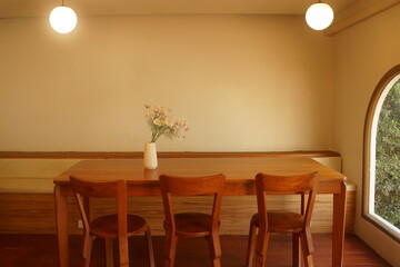 Cozy dining room with wooden table and chairs in a modern home interior