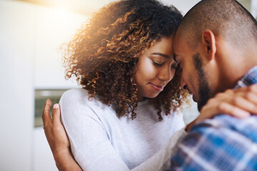 Happy couple, relax and hug with comfort or embrace for love, empathy or compassion at home. Man,...