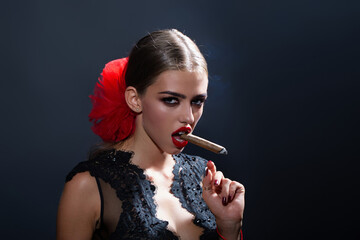 Obraz premium Beauty fashion woman smoking cigar. Elegant woman with smoke cigar. Sexy model Smoking cigar. Sensual Woman red lips. Beautiful girl blowing smoke. Girl with cigarette. Sexy model with cigar.