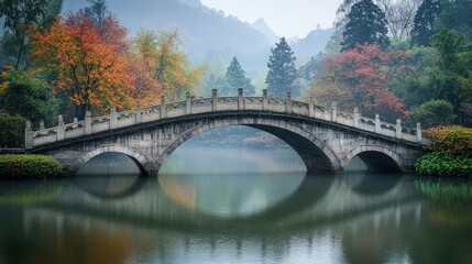 Fototapeta premium Serene Bridge Reflection: A classic stone arch bridge spans a still lake, its reflection perfectly mirrored in the tranquil water. The surrounding foliage bursts with vibrant autumn colors.