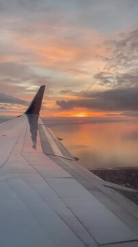 Video taken from an airplane window showing a beautiful cloudscape during sunset.
