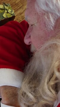 Santa claus sleeping at desk while writing a letter with a quill