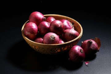 Fresh red onions in a bamboo basket. Harvest concepts. Organic vegetables.