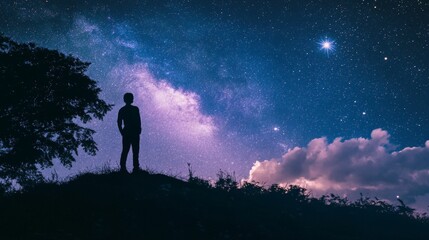 Fototapeta premium Silhouette of a person standing under a starry sky and clouds.