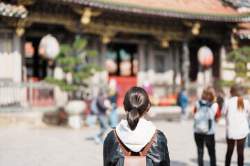 woman traveler visiting in Taiwan, female Tourist sightseeing at Longshan Temple, Chinese folk...