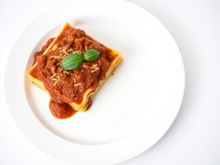 Italian style lasagna with bolognese sauce on a white ceramic plate, ground beef, tomato sauce, lasagna noodles