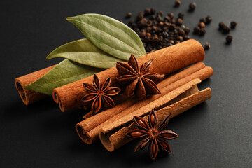traditional spices.anise stars, cinnamon, black peppers and bay leaf on black background