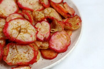 Close up of spicy seblak crackers on white isolated plate