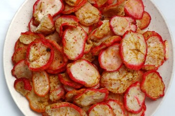 Close up of spicy seblak crackers on white isolated plate
